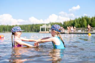 Children are swimming at the beach.