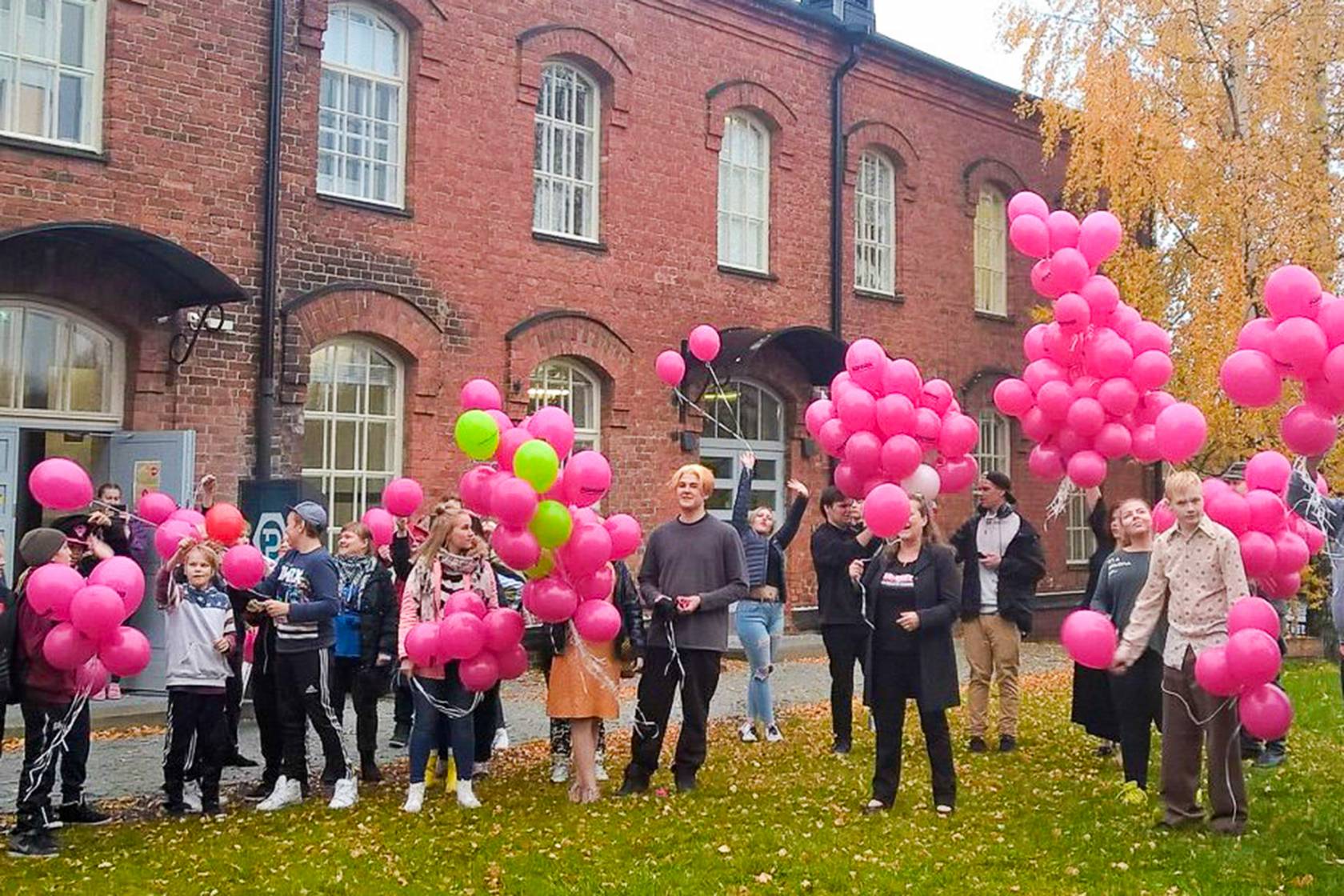 Nuoret seisovat ilmapallojen kanssa Nuorisokeskus Pultin edessä