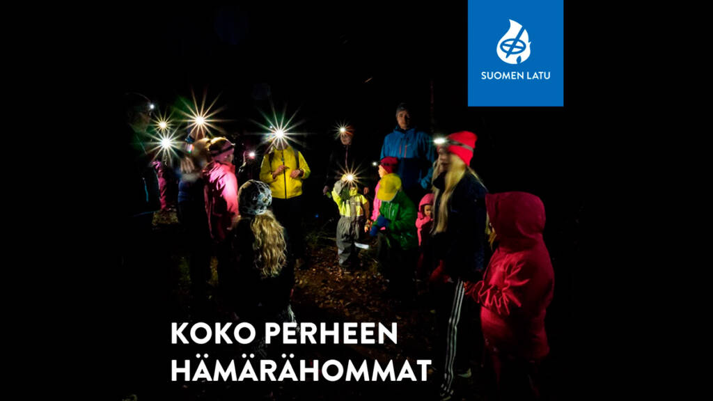 Lapsia taskulamppujen kanssa pimeässä.