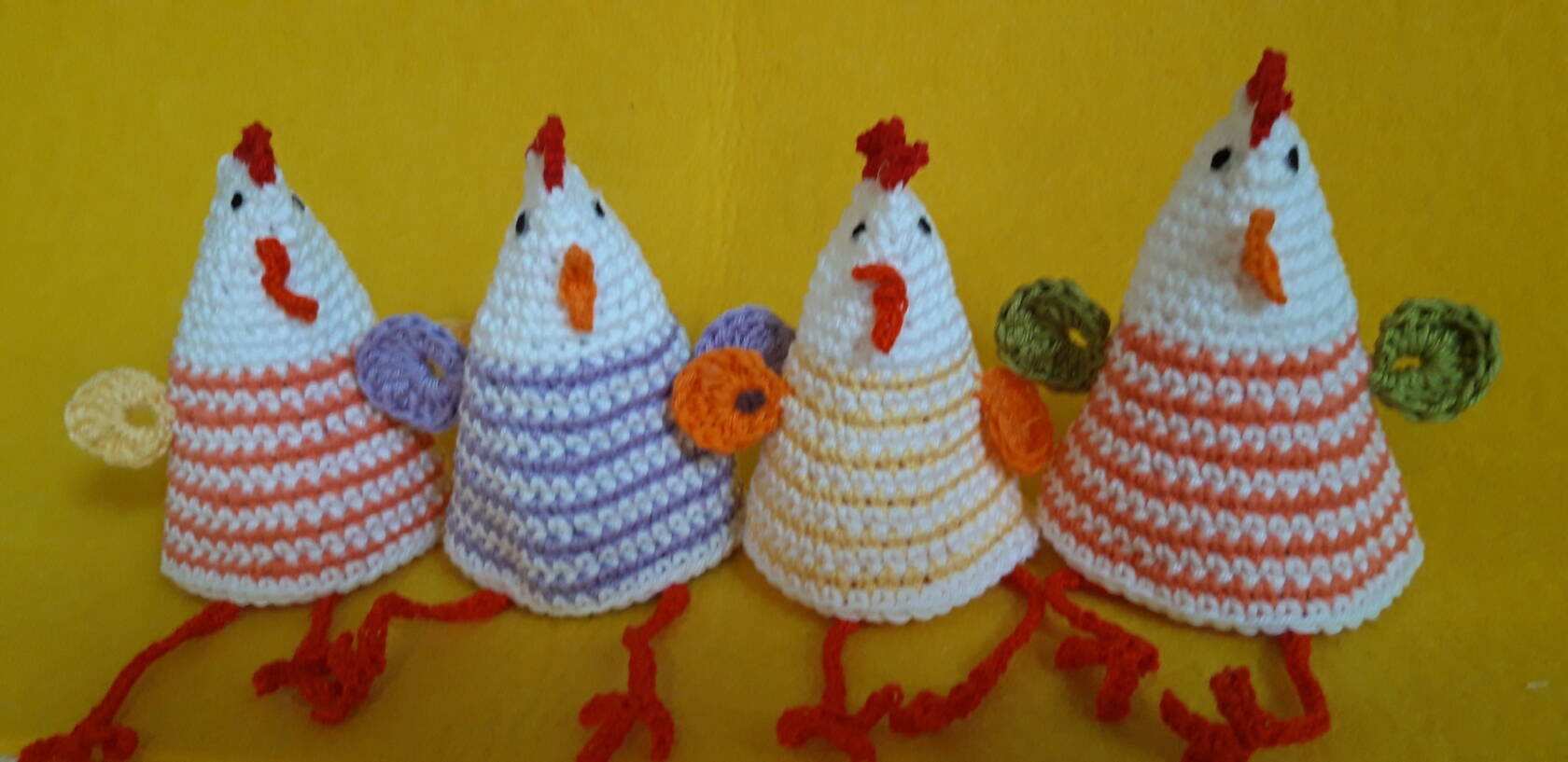 Neljä käsinkudottua kanaa.