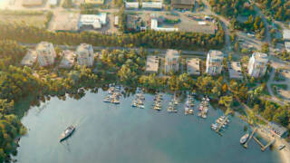 Havainnekuva kerrostaloalueesta veden äärellä.