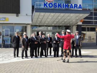 Valkeakosken mieslaulajat esiintyvät liikekeskus Koskikaran edessä.