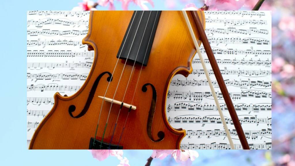 Nuottivihon päällä on ruskea viulu.